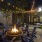 a room with tables and chairs and a fire in it