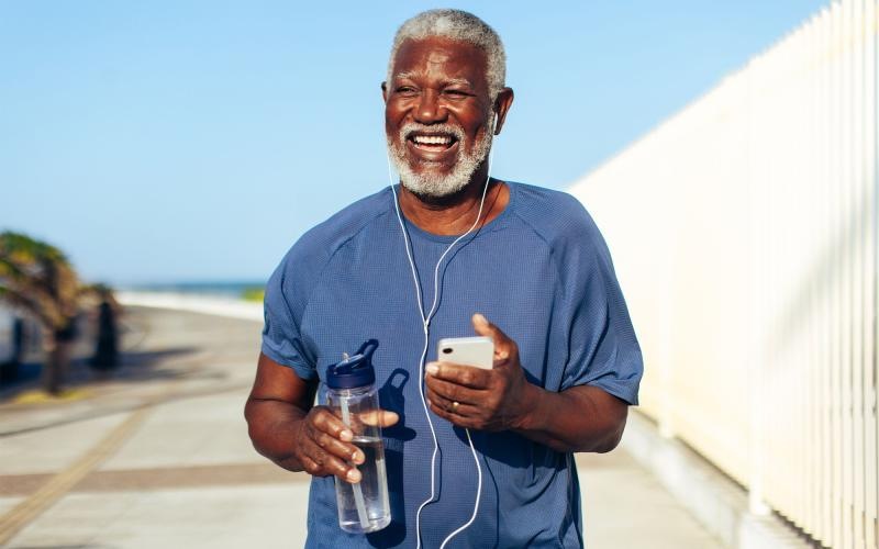 a man holding a water bottle while outdoors