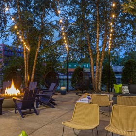 Settle into comfort at Infinity Lofts in the Gulch a group of chairs and tables outside