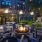 a courtyard with chairs and tables and a fountain in it